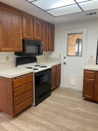 a kitchen with stainless steel appliances granite countertop a stove microwave and cabinets