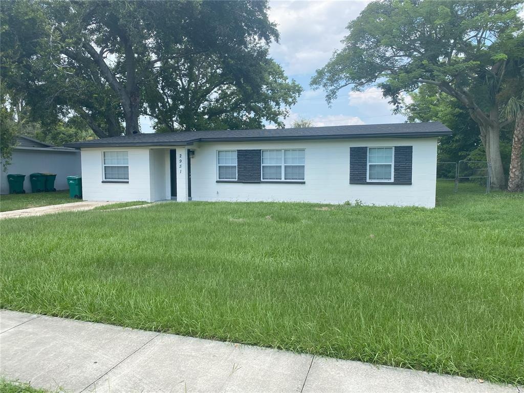 a house that has a tree in front of it