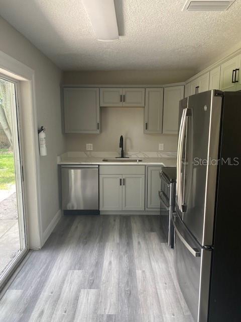 2951 Northland Road Mount Dora, FL 32757 - Photo 2 of 11 a kitchen with white cabinets and wooden floor