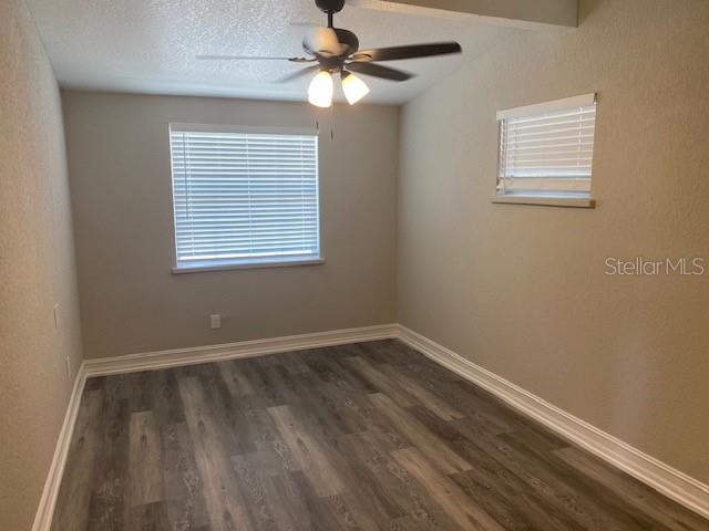 2951 Northland Road Mount Dora, FL 32757 - Photo 5 of 11 a view of an empty room with wooden floor and a window