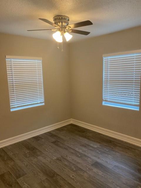 2951 Northland Road Mount Dora, FL 32757 - Photo 7 of 11 a view of an empty room with wooden floor and a window
