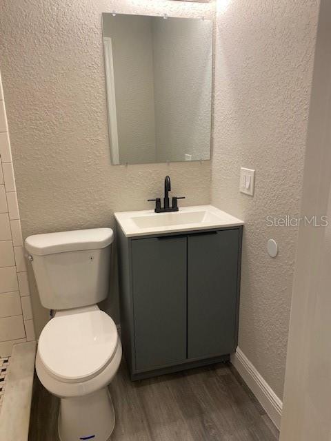 2951 Northland Road Mount Dora, FL 32757 - Photo 8 of 11 a bathroom with a toilet sink and mirror