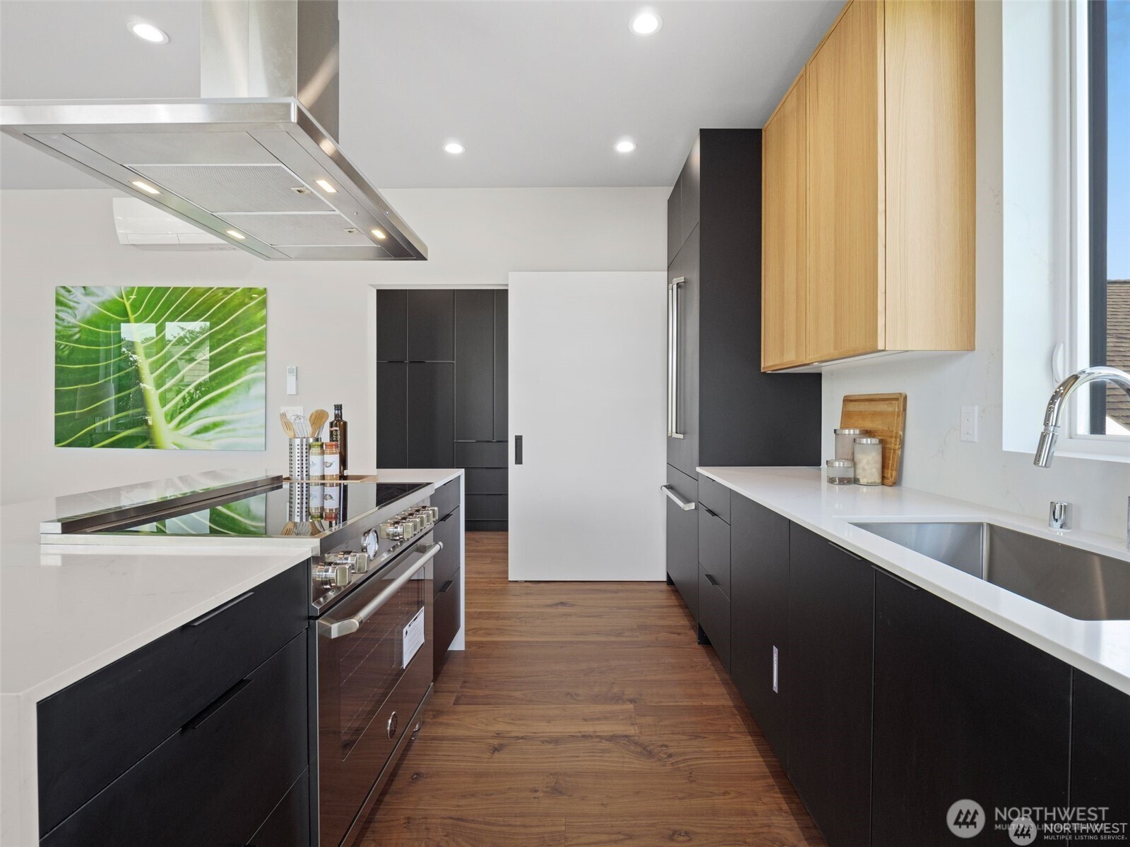 4464 Midvale Avenue North Seattle, WA 98103 - Photo 17 of 27 a kitchen with stainless steel appliances a sink stove and cabinets