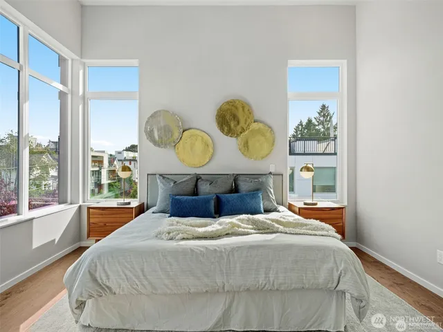 a bed sitting in a bedroom next to a window