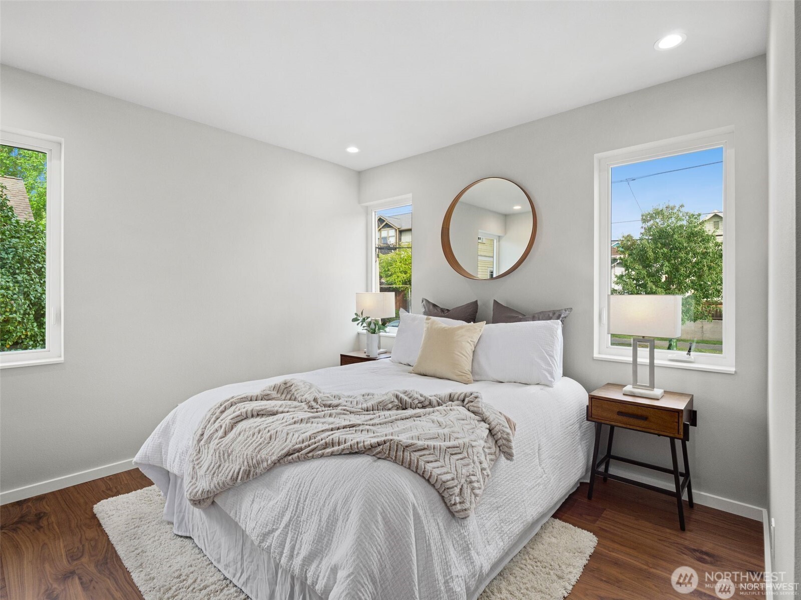 4464 Midvale Avenue North Seattle, WA 98103 - Photo 4 of 27 a bedroom with a bed lamp and a potted plant
