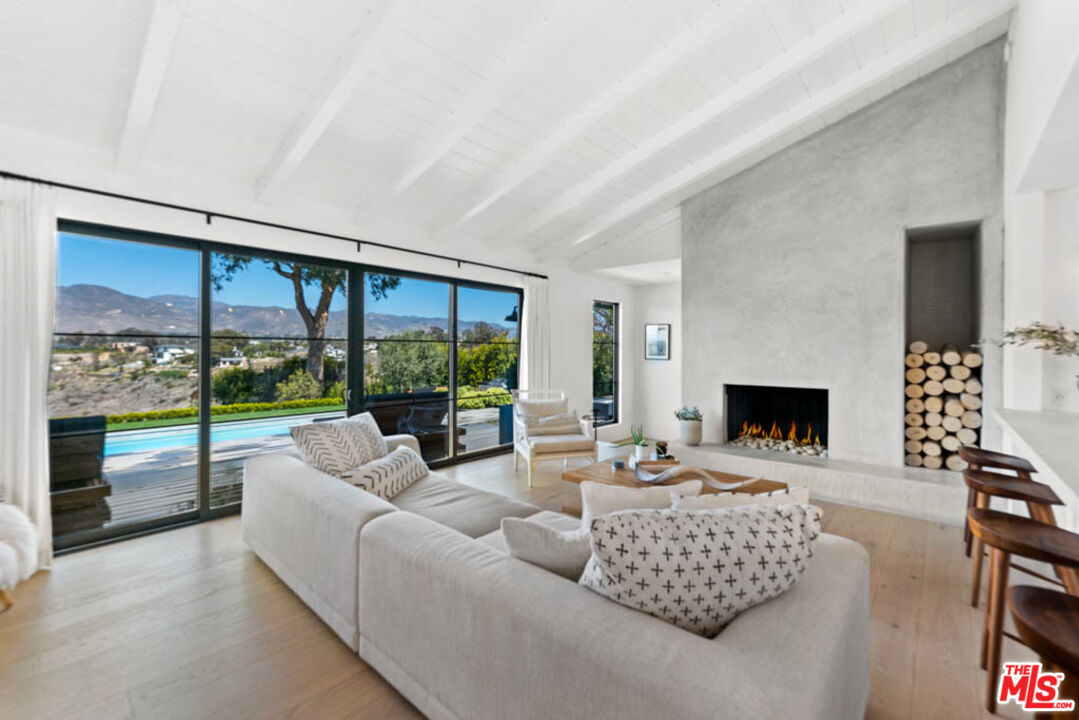 29351 Bluewater Road Malibu, CA 90265 - Photo 17 of 52 a living room with furniture fireplace and a large window