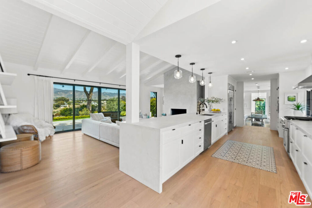 29351 Bluewater Road Malibu, CA 90265 - Photo 18 of 52 a large white room with mirror on the wall and couches