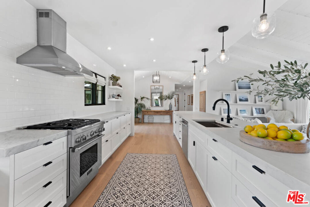 29351 Bluewater Road Malibu, CA 90265 - Photo 24 of 52 a large kitchen with stainless steel appliances granite countertop a stove and a sink