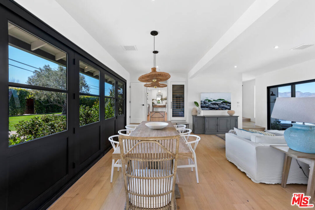 29351 Bluewater Road Malibu, CA 90265 - Photo 29 of 52 a dining room with furniture wooden floor and a chandelier
