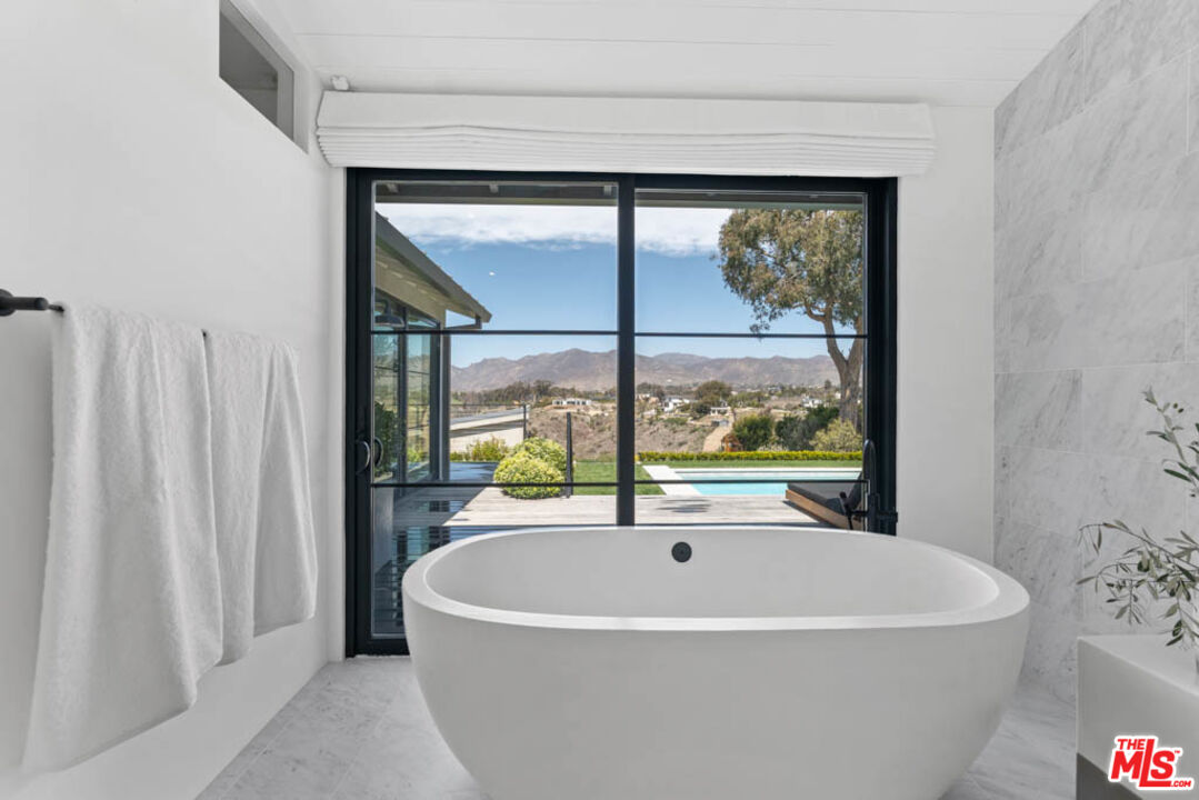 29351 Bluewater Road Malibu, CA 90265 - Photo 36 of 52 a white bath tub sitting in a bathroom next to a window