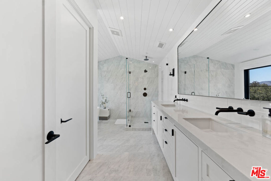 29351 Bluewater Road Malibu, CA 90265 - Photo 37 of 52 a bathroom with a double vanity sink mirror and shower