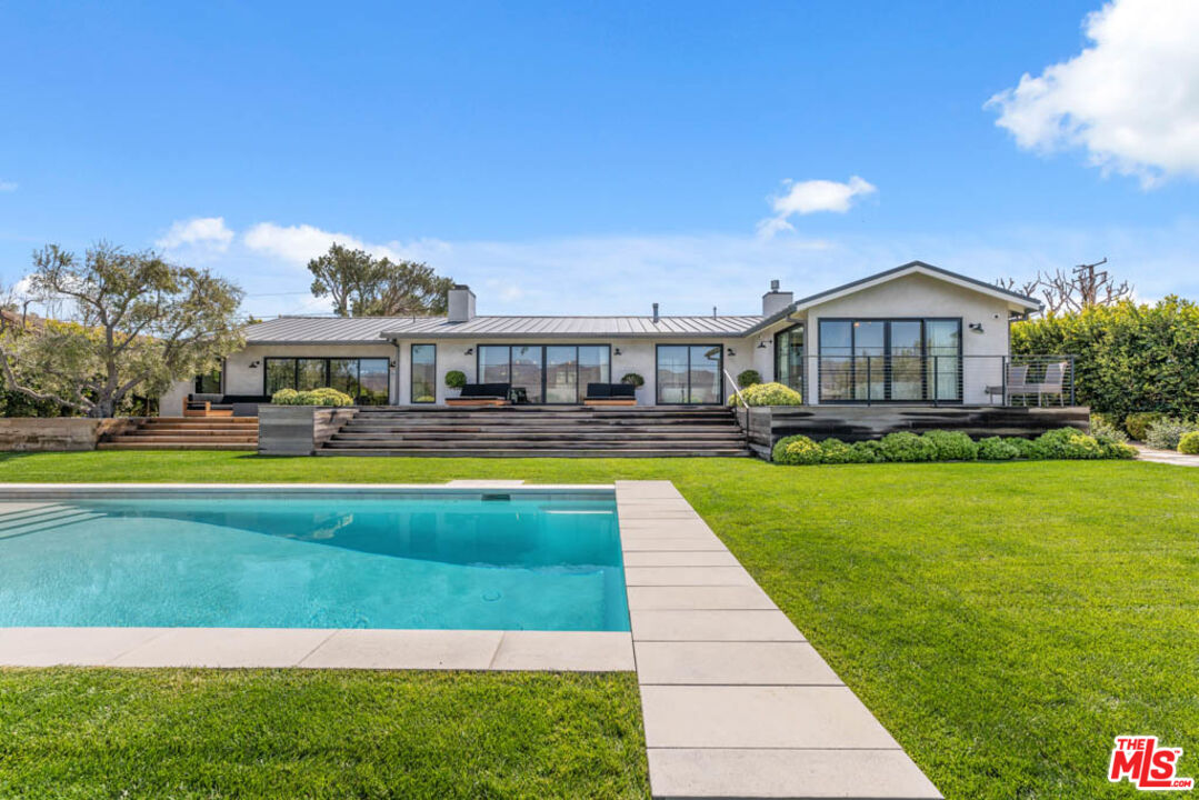 29351 Bluewater Road Malibu, CA 90265 - Photo 4 of 52 a swimming pool view with a seating space and a garden view