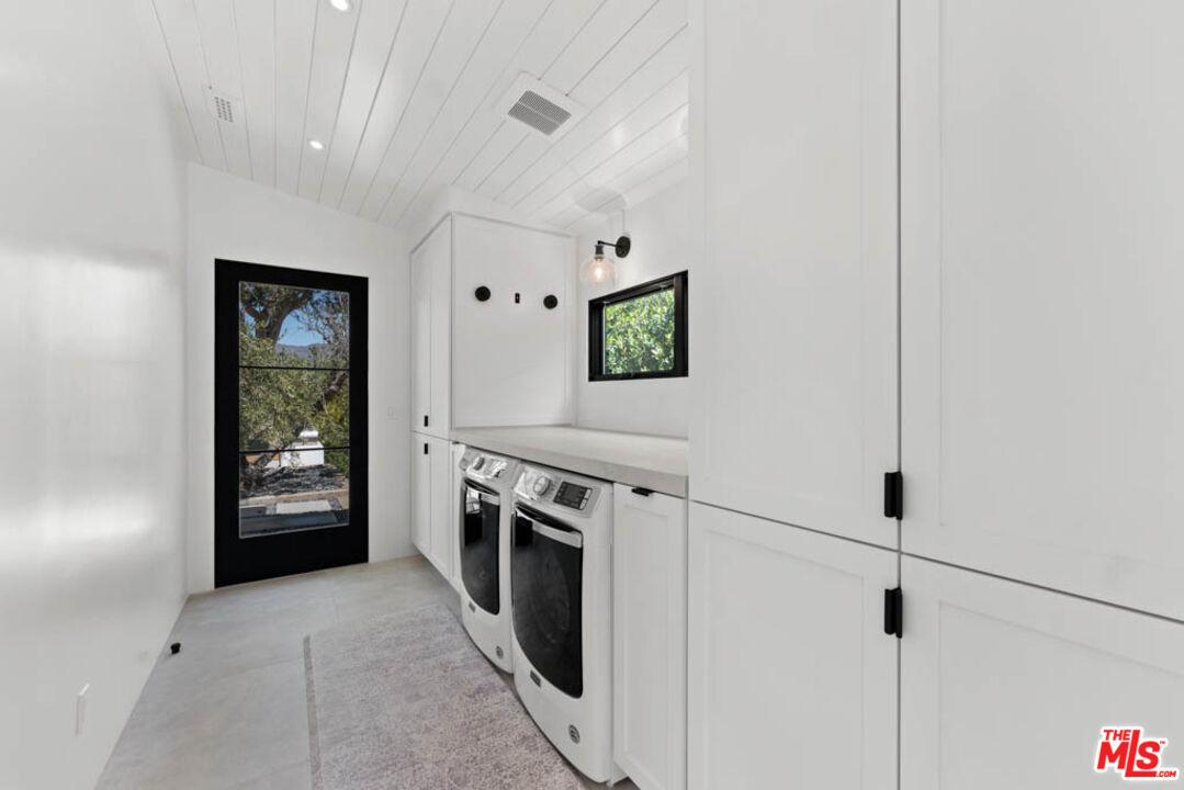 29351 Bluewater Road Malibu, CA 90265 - Photo 43 of 52 a kitchen with stainless steel appliances granite countertop cabinets and a stove top oven
