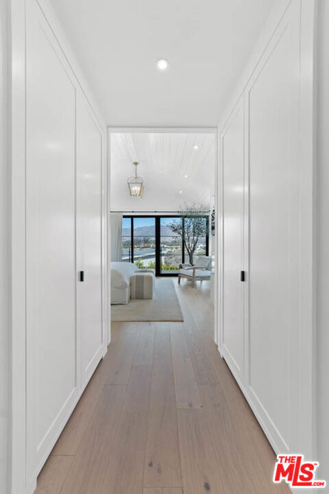 29351 Bluewater Road Malibu, CA 90265 - Photo 46 of 52 a view of a hallway with wooden floor and windows