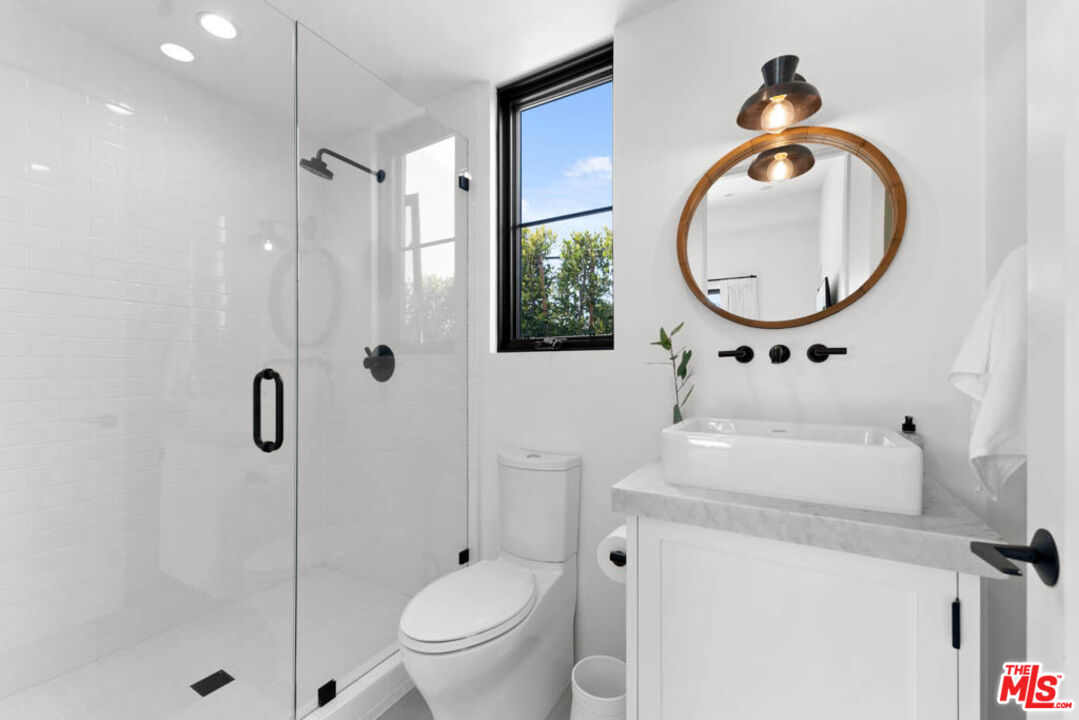 29351 Bluewater Road Malibu, CA 90265 - Photo 49 of 52 a bathroom with a toilet a sink and a mirror