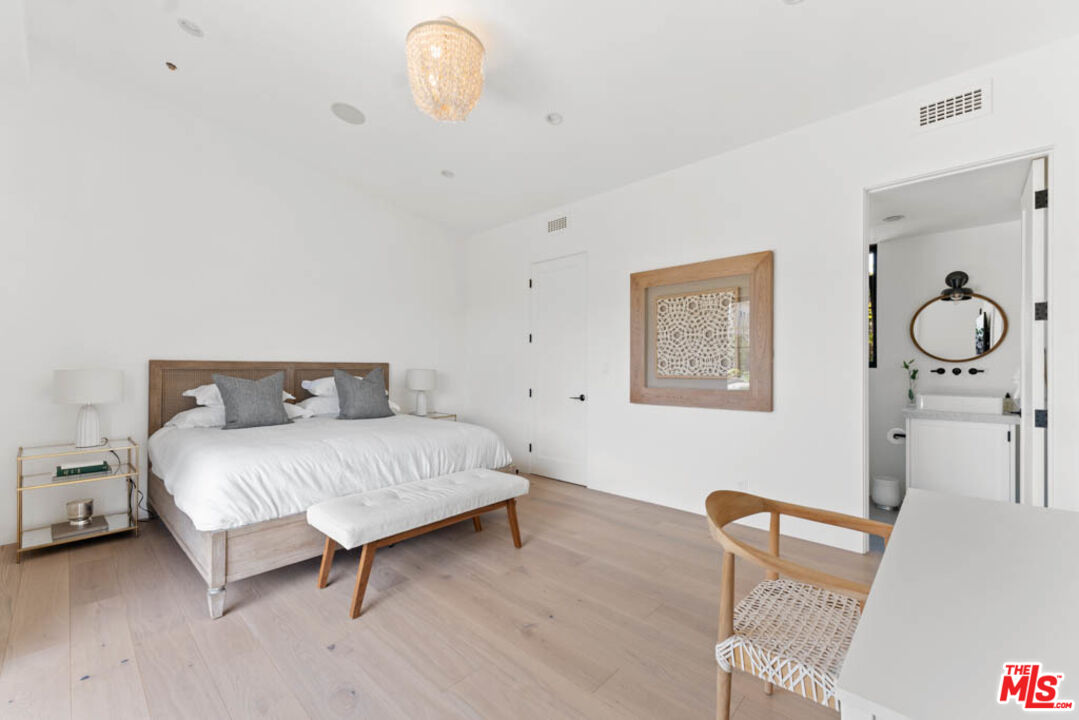 29351 Bluewater Road Malibu, CA 90265 - Photo 50 of 52 a spacious bedroom with a bed and chair