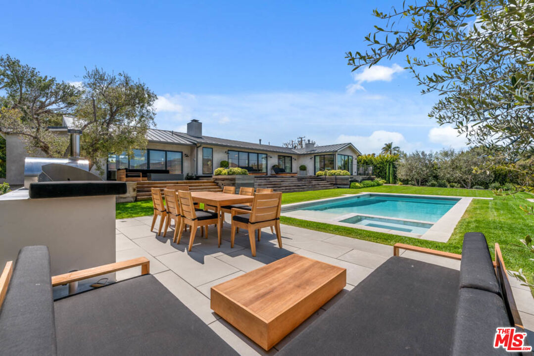 29351 Bluewater Road Malibu, CA 90265 - Photo 9 of 52 a view of a swimming pool with lawn chairs and a yard