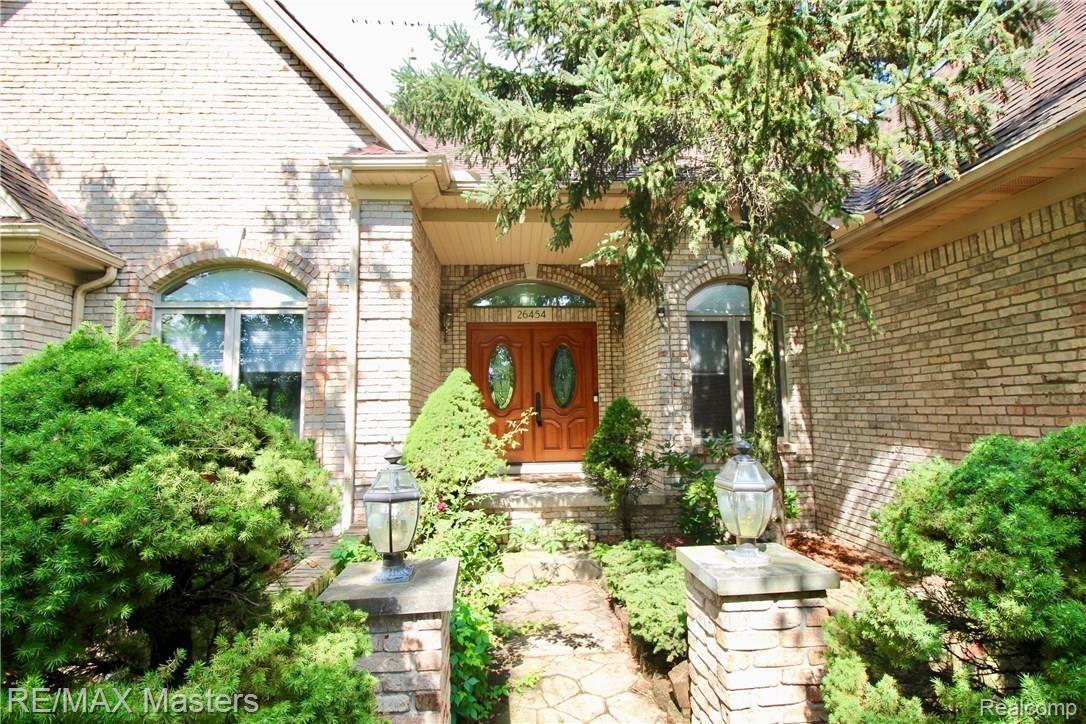 Private entry to this stunning architectural beauty is protected by trees, and features brick pillars, and perennials as do all the landscaping beds!