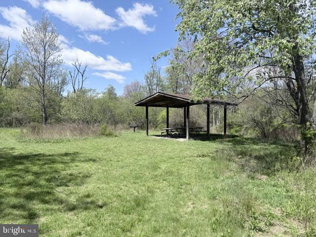 Turkey Neck Road Swanton, MD 21561 - Photo 22 of 23 a backyard of a house with table and chairs