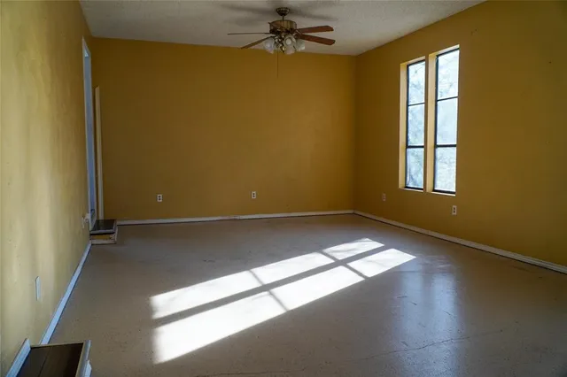 an empty room with a empty space and windows