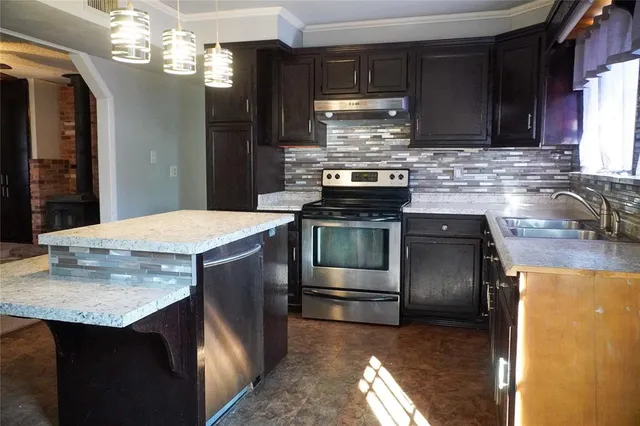 a kitchen with a stove and a sink