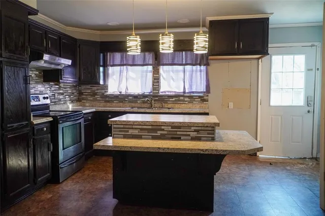a kitchen with stainless steel appliances granite countertop a stove and a refrigerator