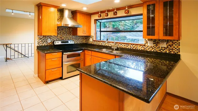 a kitchen with stainless steel appliances granite countertop a stove and a refrigerator