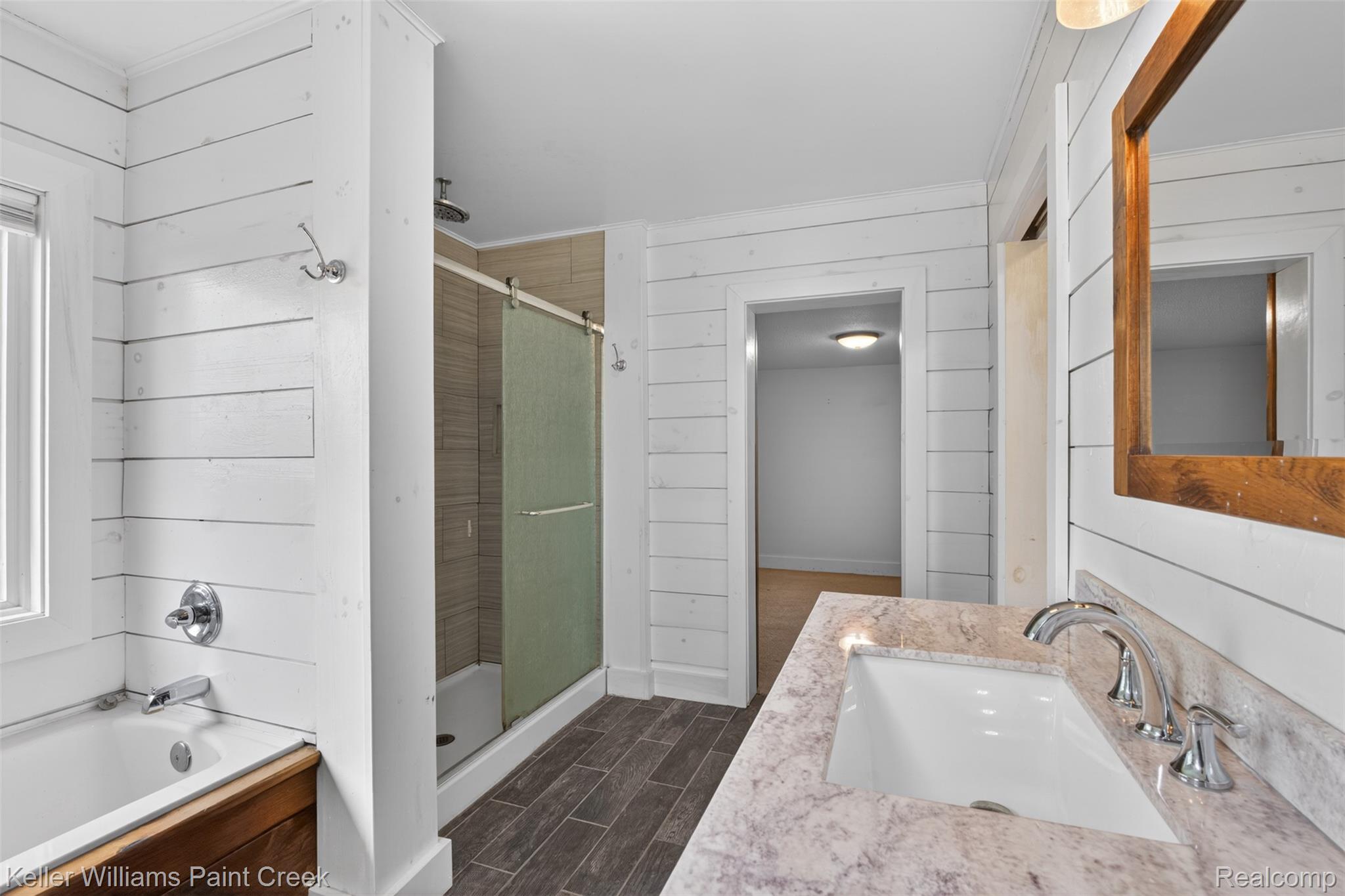 18125 Nelson Road St. Charles, MI 48655 - Photo 26 of 63 Full bath featuring a stall shower, vanity, wooden walls, a bath, and wood tiled floors