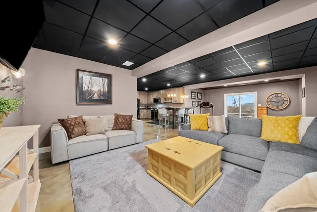 a front view of a house with a yard and trees