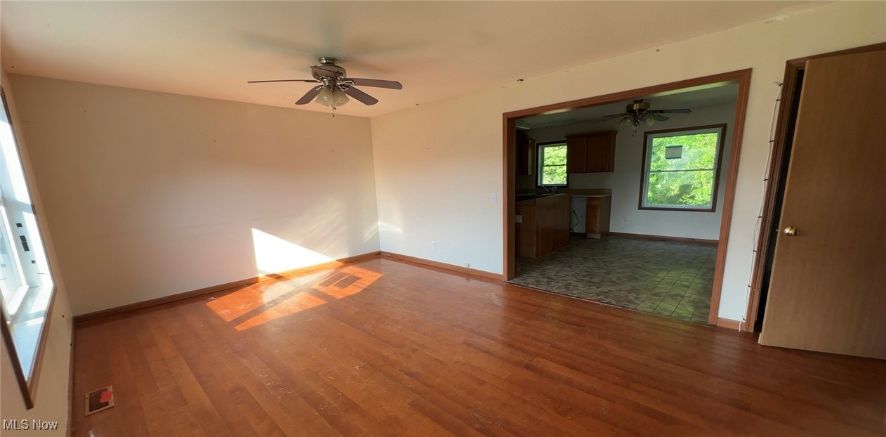4965 Workman Road Roseville, OH 43777 - Photo 5 of 10 Unfurnished room with ceiling fan and wood finished floors