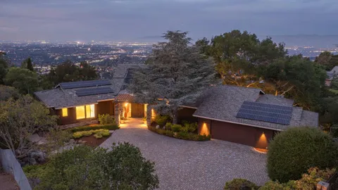 a view of a house with a yard next to a house