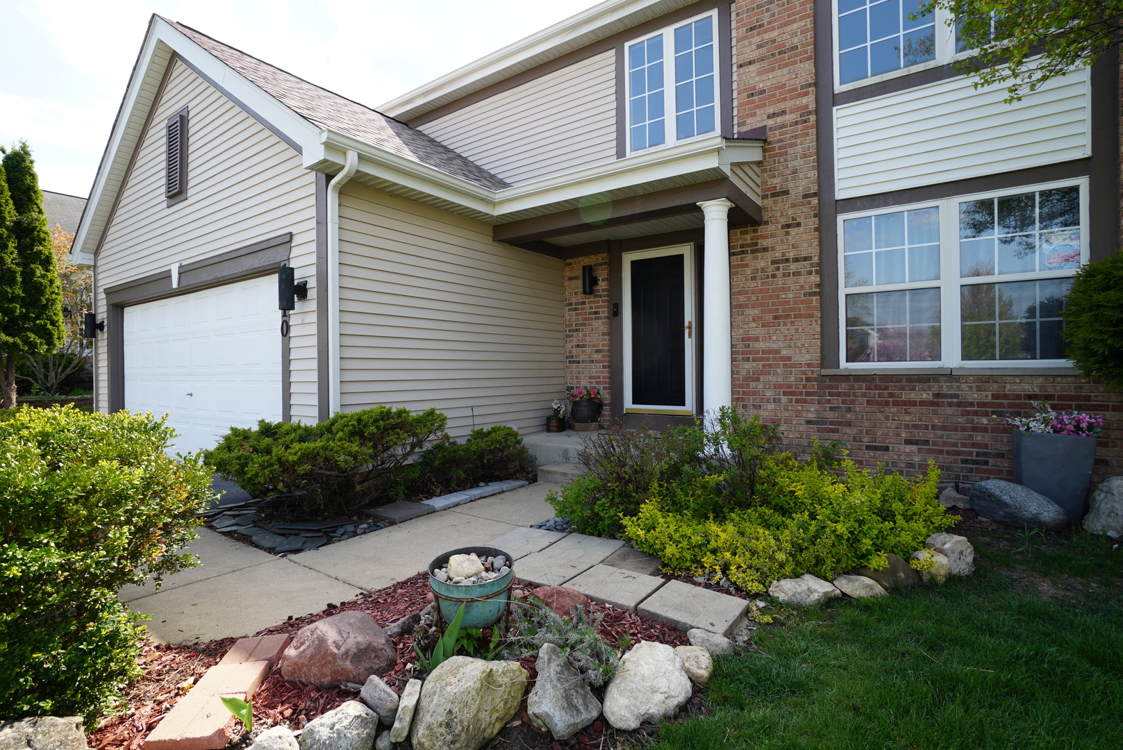 1910 Avalon Drive Wheeling, IL 60090 - Photo 2 of 36 a front view of a house with a yard