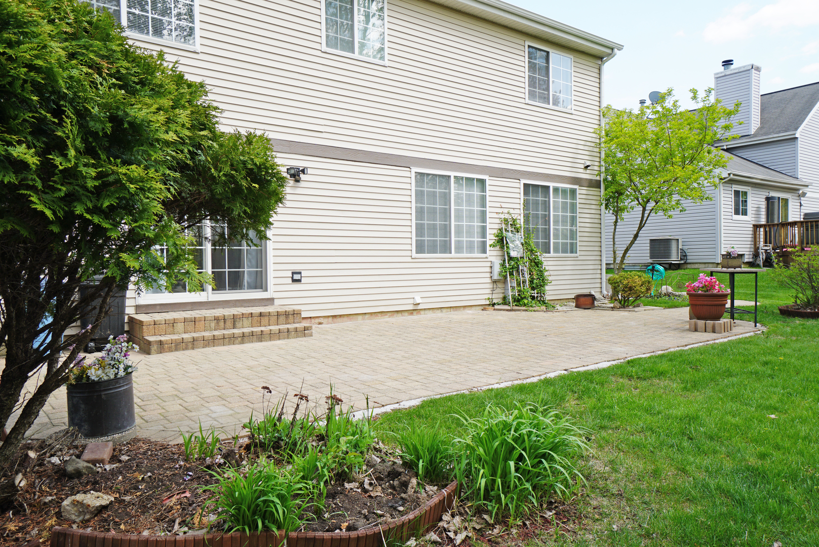 1910 Avalon Drive Wheeling, IL 60090 - Photo 27 of 36 a front view of a house with a yard and potted plants