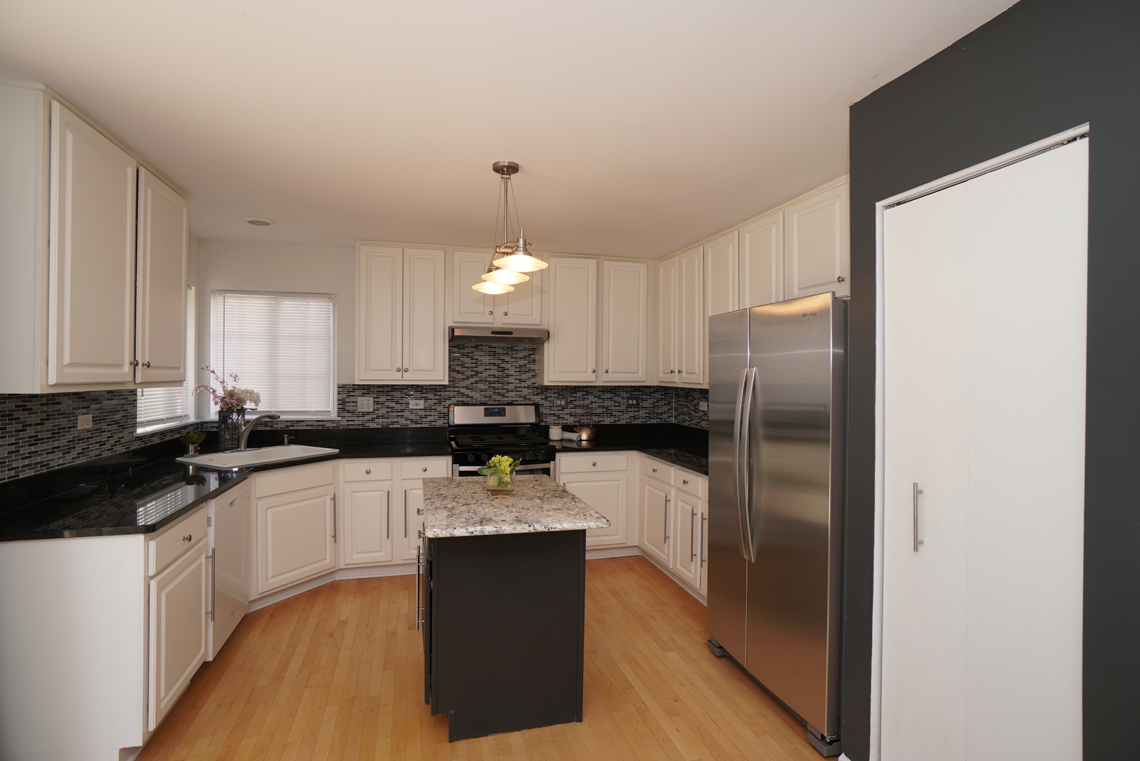 1910 Avalon Drive Wheeling, IL 60090 - Photo 5 of 36 a kitchen with a refrigerator a sink a stove and cabinets