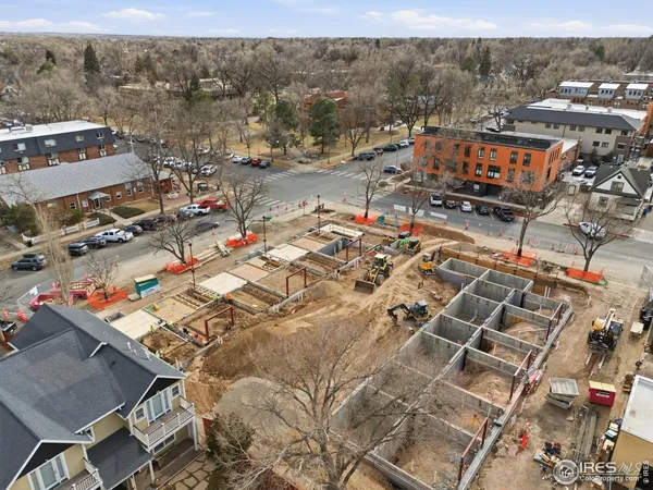 an aerial view of residential houses with city view