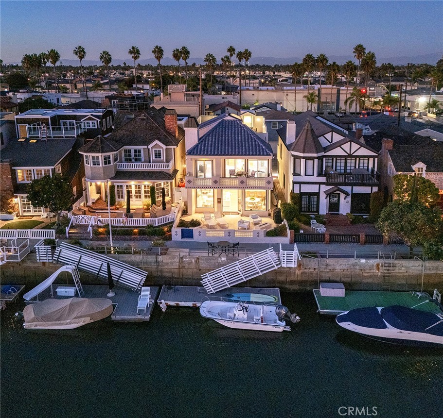 an aerial view of a house with swimming pool fire pit and outdoor seating
