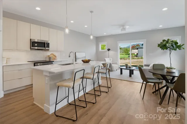 a view of a dining room with furniture and a potted plant