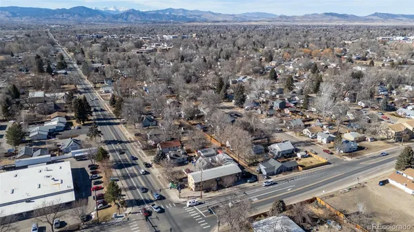 an aerial view of a city and mountain view in back