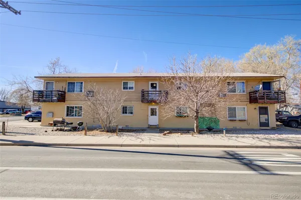 a view of building with car parked