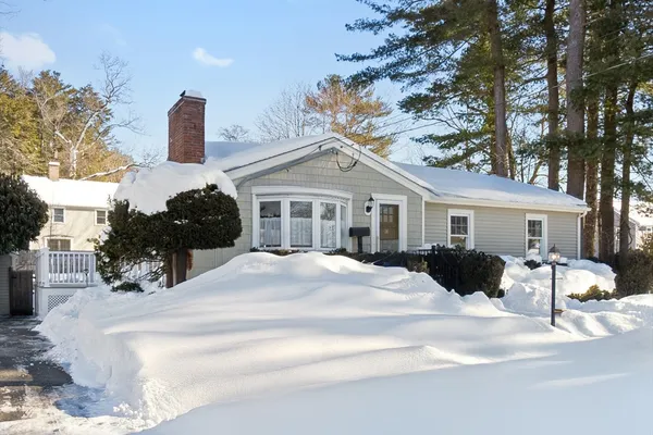 a view of a house with a yard covered in snow