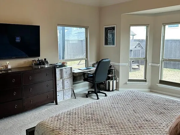 a view of a workspace with furniture and a window