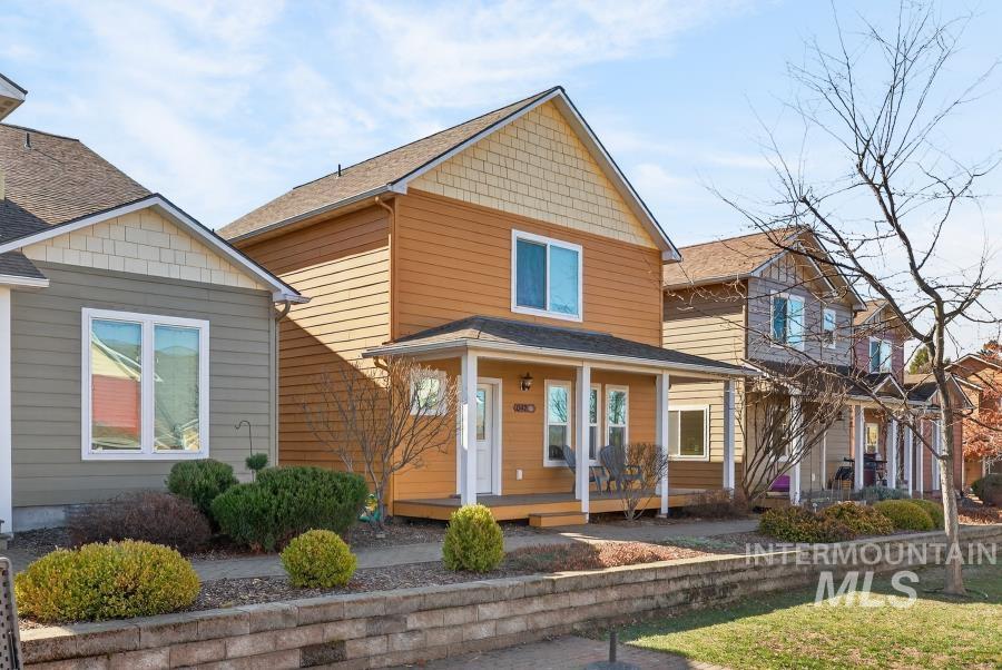 View of front of property with covered porch and a shingled roof