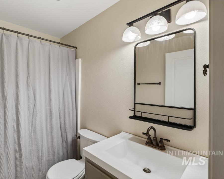 1342 Bristol Road Moscow, ID 83843 - Photo 21 of 26 Bathroom with vanity, a shower with shower curtain, and a textured wall