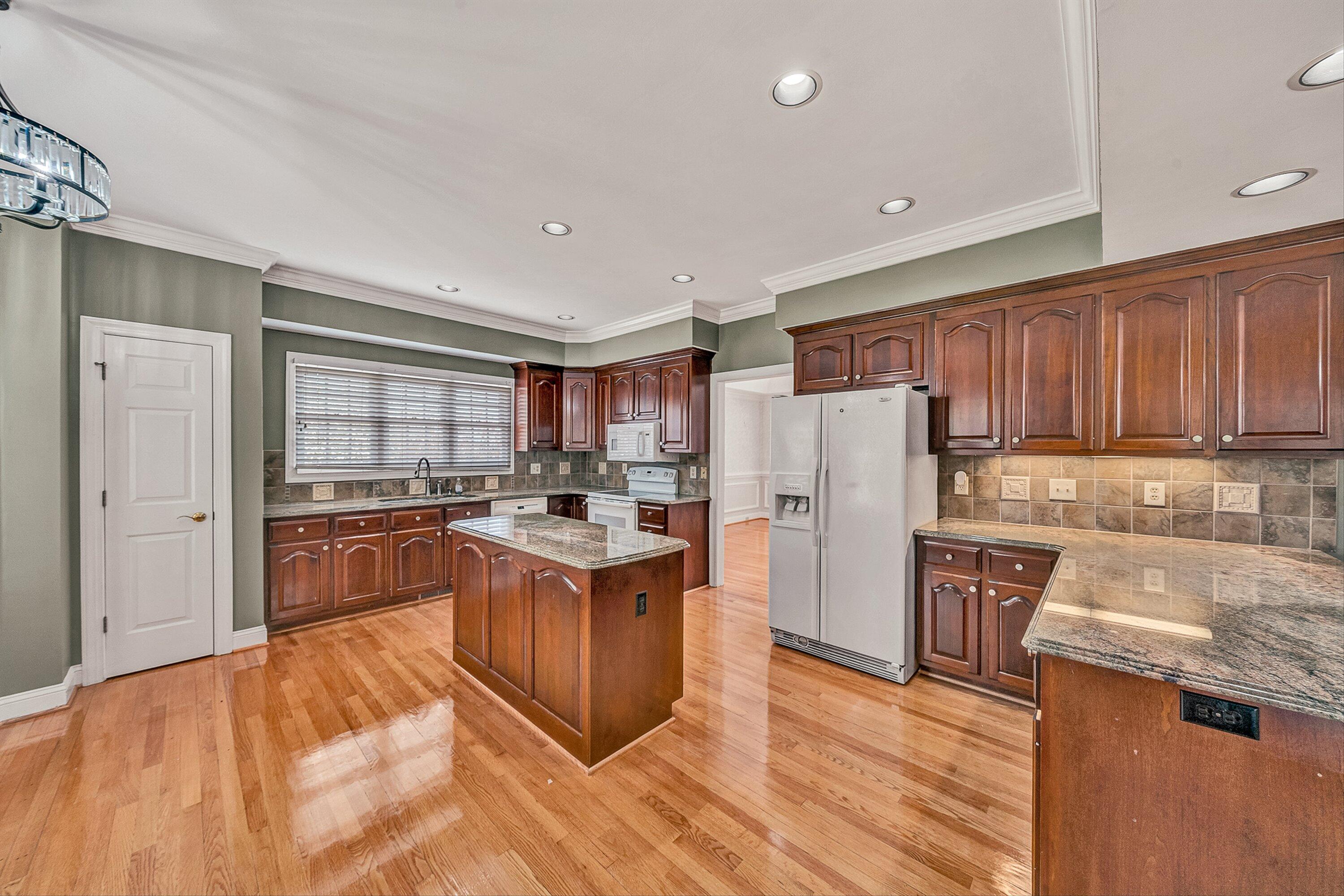 8317 Cardington Drive Roanoke, VA 24019 - Photo 11 of 43 a kitchen with granite countertop wooden floors and white stainless steel appliances