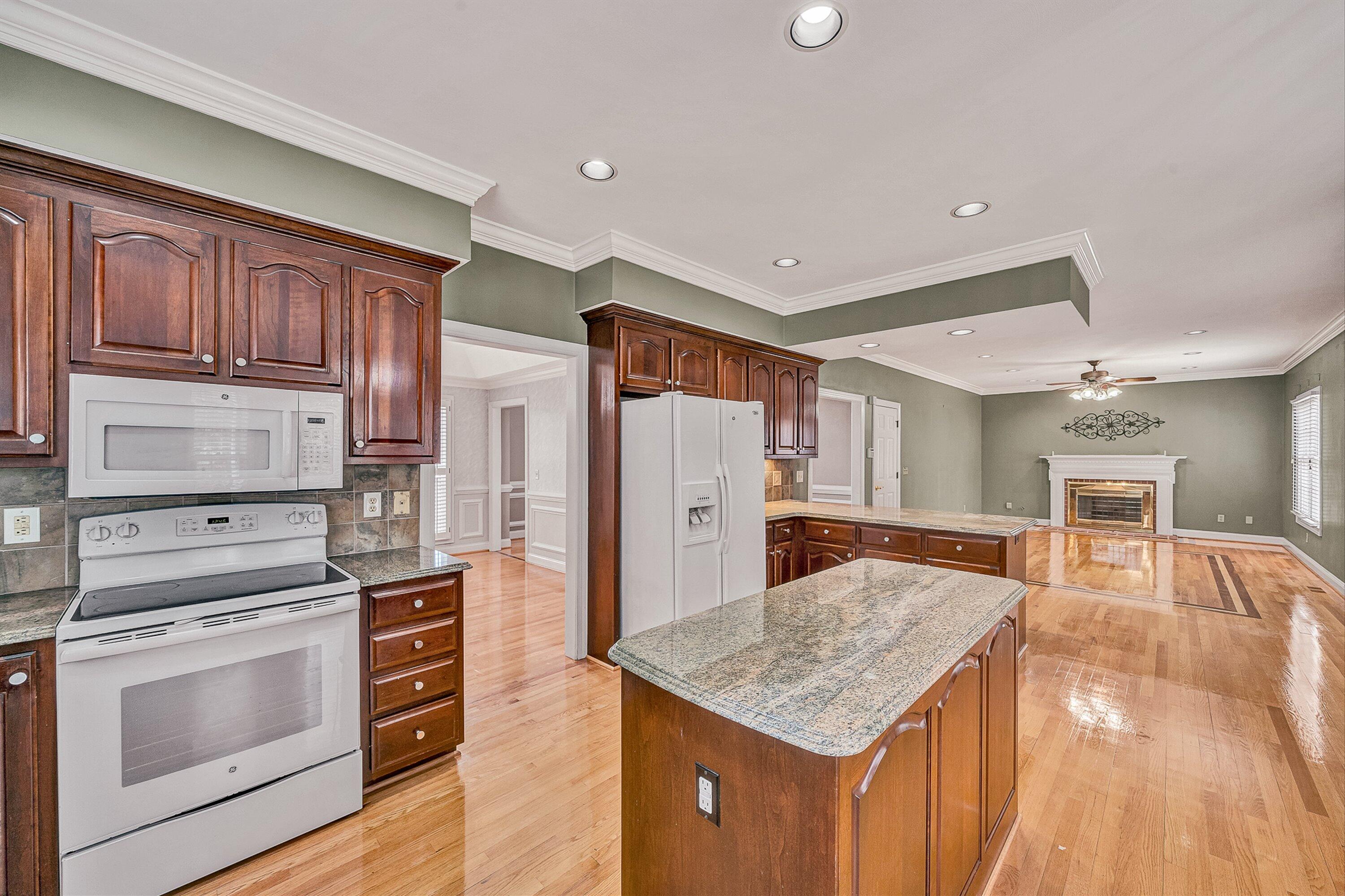 8317 Cardington Drive Roanoke, VA 24019 - Photo 13 of 43 a kitchen with stainless steel appliances granite countertop a refrigerator a stove and a wooden floors