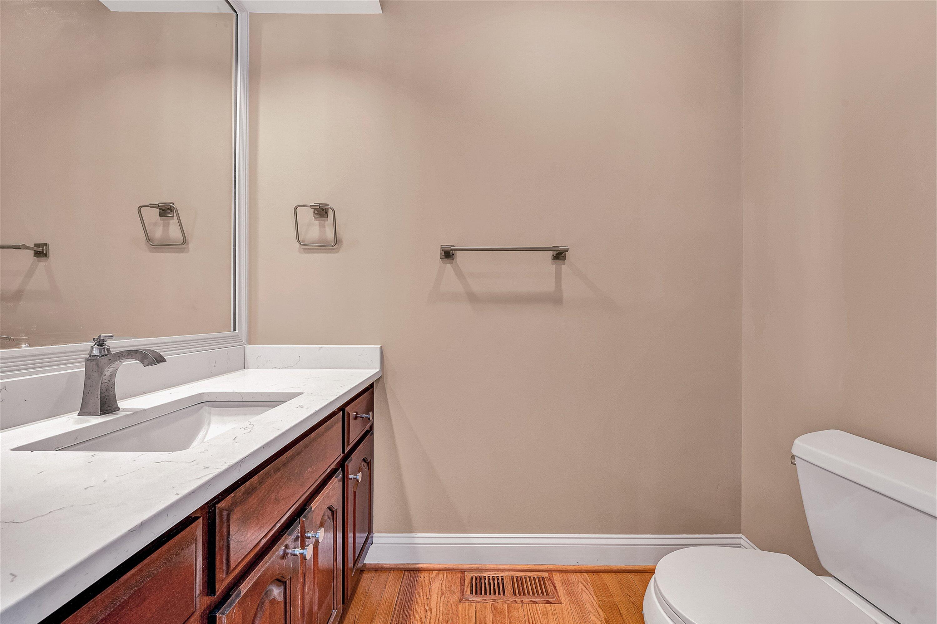 8317 Cardington Drive Roanoke, VA 24019 - Photo 5 of 43 a bathroom with a granite countertop sink vanity mirror and toilet