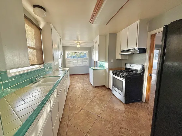 a kitchen with a sink stove and refrigerator