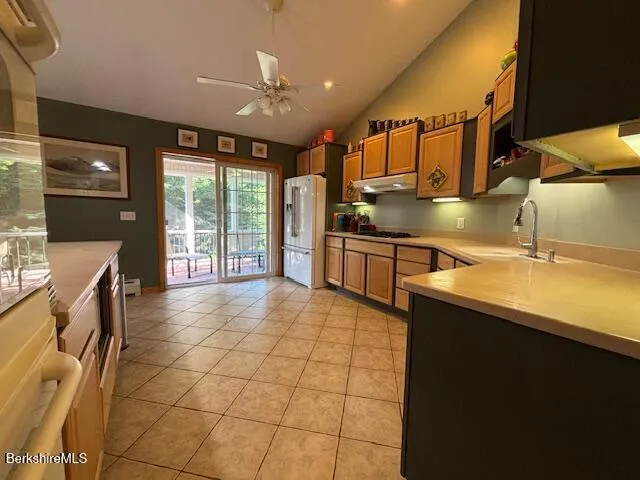 a kitchen with stainless steel appliances a sink stove and cabinets