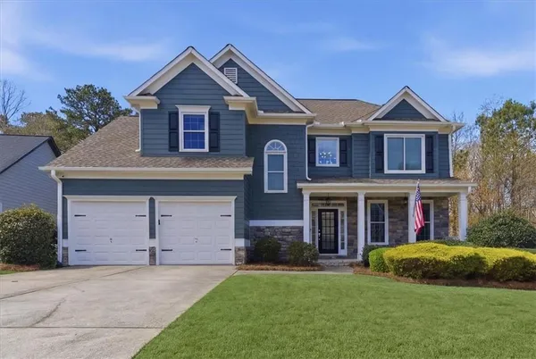 a front view of a house with a yard and garage