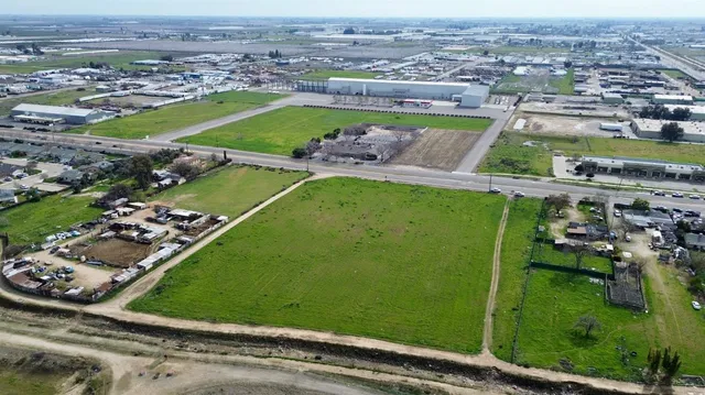 an aerial view of a residential houses with outdoor space